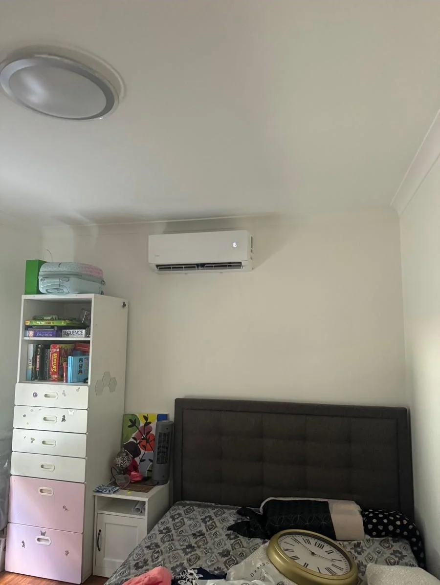Energy-efficient wall-mounted air conditioner installed in a second bedroom